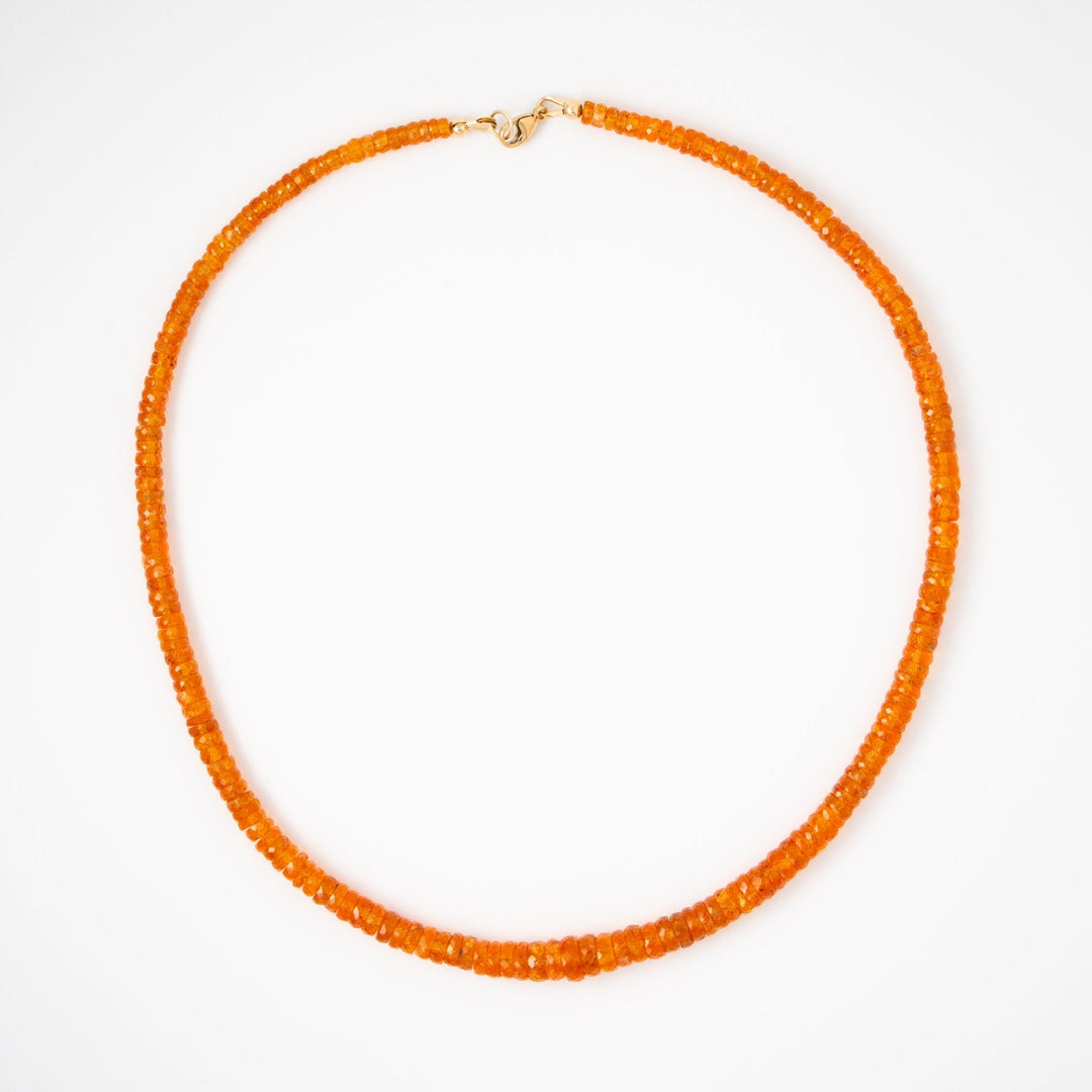 Orange garnet beaded necklace on a white background