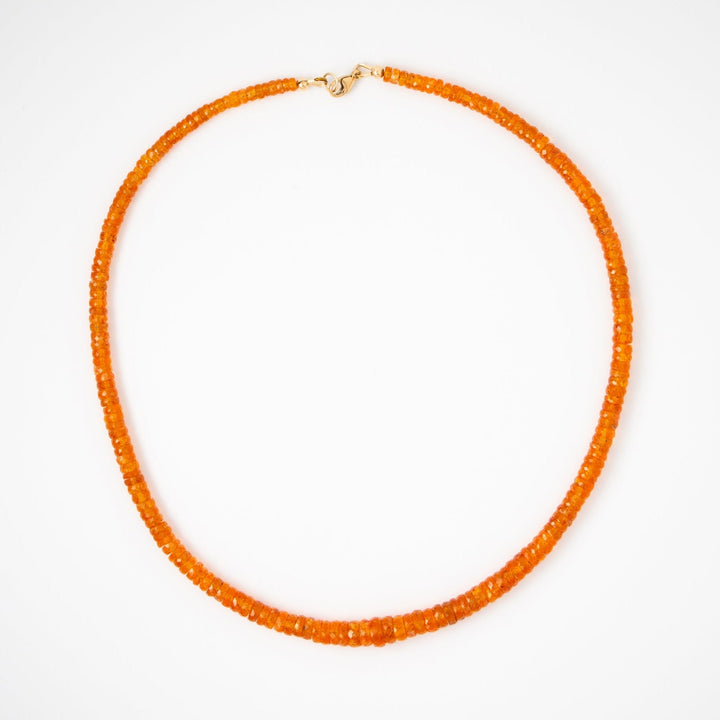 Orange garnet beaded necklace on a white background